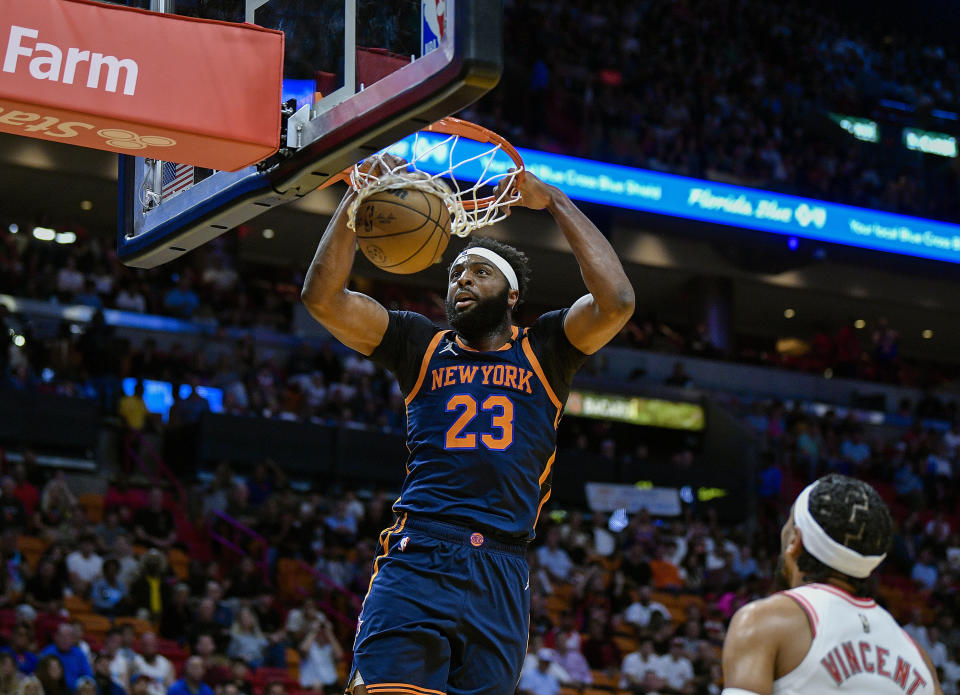 New York Knicks center Mitchell Robinson (23) dunks the ball in front of Miami Heat guard Gabe Vincent (2) during the first half of an NBA basketball game, Wednesday, March 22, 2023, in Miami, Fla. (AP Photo/Michael Laughlin)