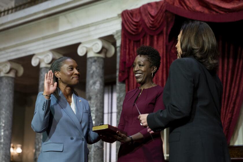 Vice President Kamala Harris, right, swears in Laphonza Butler, D-Calif., left, to the Senate to succeed the late Sen. Dianne Feinstein during a re-enactment of the swearing-in ceremony on Tuesday, Oct. 3, 2023, on Capitol Hill in Washington. Butler's wife, Neneki Lee, center, holds the Bible. (AP Photo/Stephanie Scarbrough)