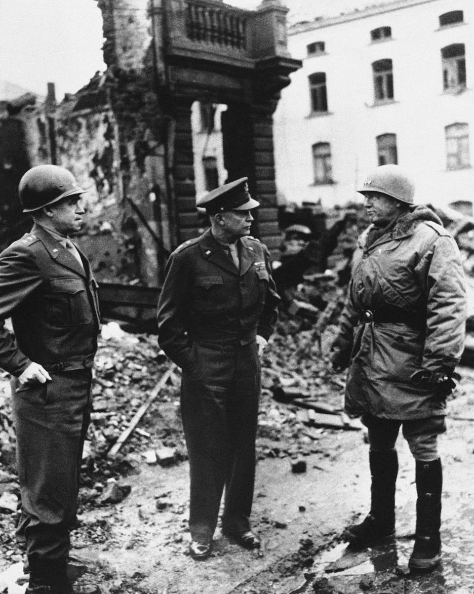 FILE - In this Feb. 5, 1945, file photo, from left, Lt. Gen. Omar Bradley, commander, U.S. Twelfth Army Group; Supreme Allied Commander Dwight D. Eisenhower; and Gen. George S. Patton, commander, U.S. Third Army, survey the damage in Bastogne, Belgium. In 2020, the world marked the 75th anniversary of the end of World War II. Sterling Publishing, in cooperation with The Associated Press, released an illustrated book called “Victory: World War II In Real Time,” filled with original AP dispatches from the time to mark the occasion and scores of original news photos. (AP Photo/File)