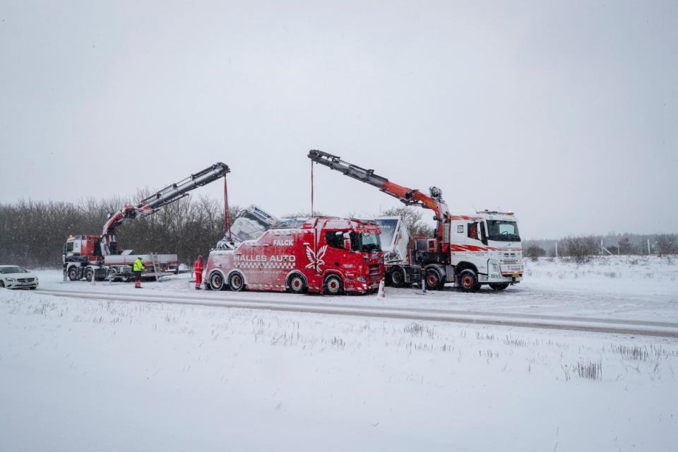A truck is being removed from the snowy street following an accident during heavy snowfall in Viborg, central Jutland, Denmark (Ritzau Scanpix/AFP via Getty Ima)