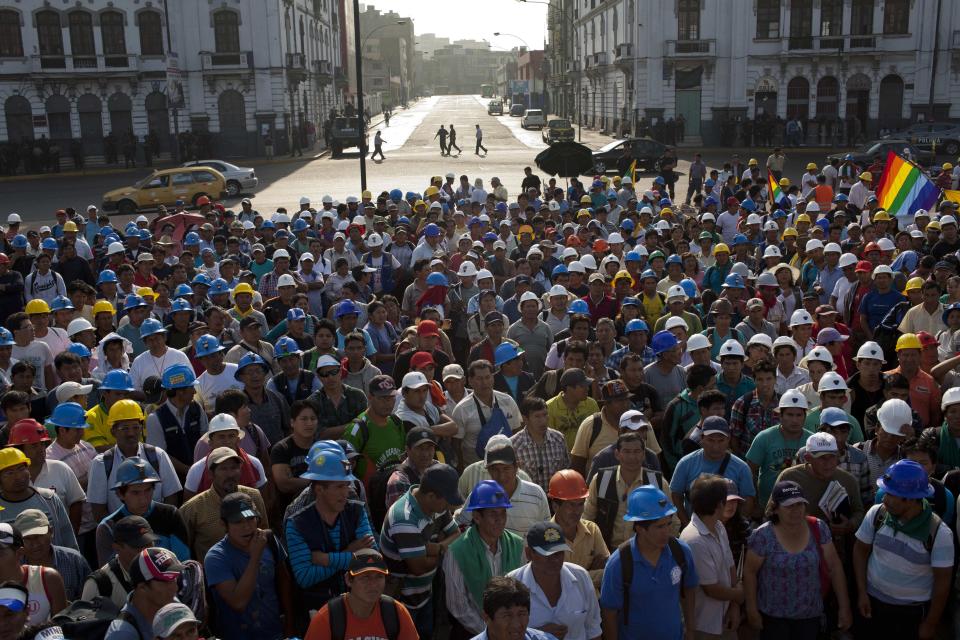 Miners listen to one of their leaders during a protest organized by artisanal and small-scale gold miners in Lima, Peru, Friday, March 21, 2014. The miners marched in the country's capital for a second day asking the government to repeal regulations aimed at formalizing informal miners. (AP Photo/Rodrigo Abd)(AP Photo/Rodrigo Abd)