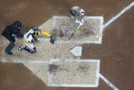 San Diego Padres' Manny Machado hiyts an RBI single during the fifth inning of a baseball game against the Milwaukee Brewers Monday, April 15, 2024, in Milwaukee. (AP Photo/Morry Gash)