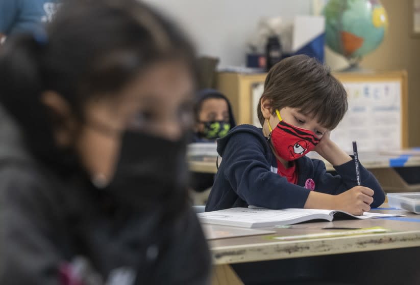 PANORAMA CITY, CA - APRIL 20: Alta California Elementary School kindergartner Louie Watkins writes in his math workbook on Tuesday, April 20, 2021 in Panorama City, CA. (Brian van der Brug / Los Angeles Times)