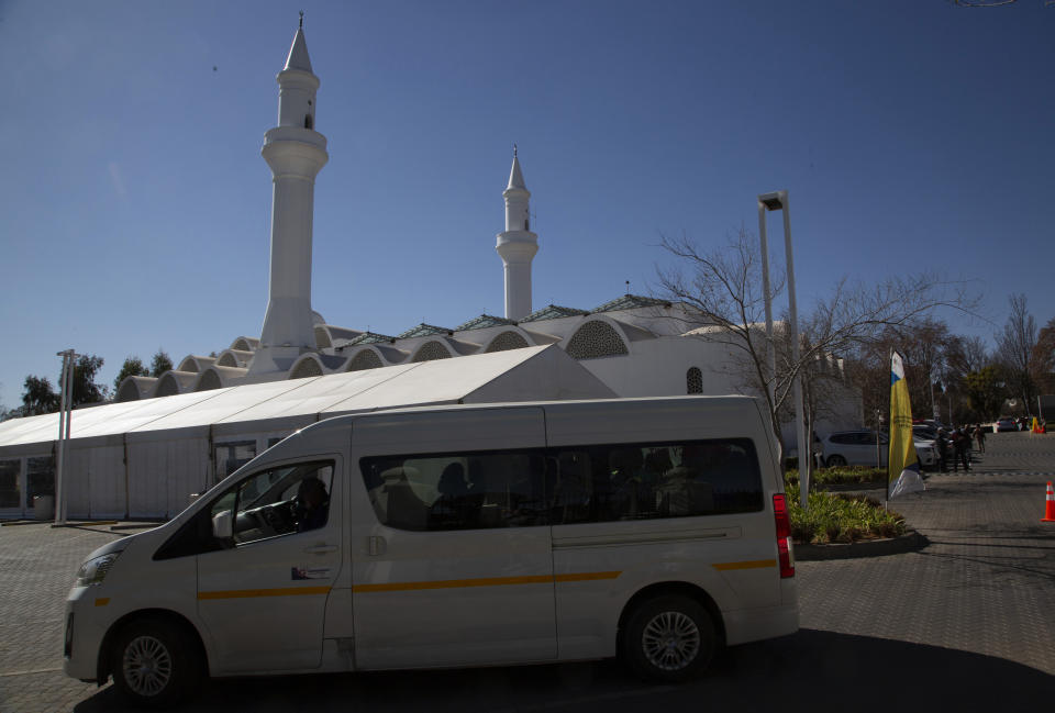 A minibus vehicle arrives at the Houghton Mosque, which is being used as a drive-thru COVID-19 vaccination centre in Johannesburg, Wednesday, July 28, 2021. Hitting its stride after a faltering start, South Africa’s mass vaccination campaign gave jabs to 220,000 people a day last week and is accelerating toward the goal of 300,000 per day. With large deliveries of doses arriving and some vaccines being assembled here, South Africa appears on track to inoculate about 35 million of its 60 million people by the end of the year. (AP Photo/Denis Farrell)