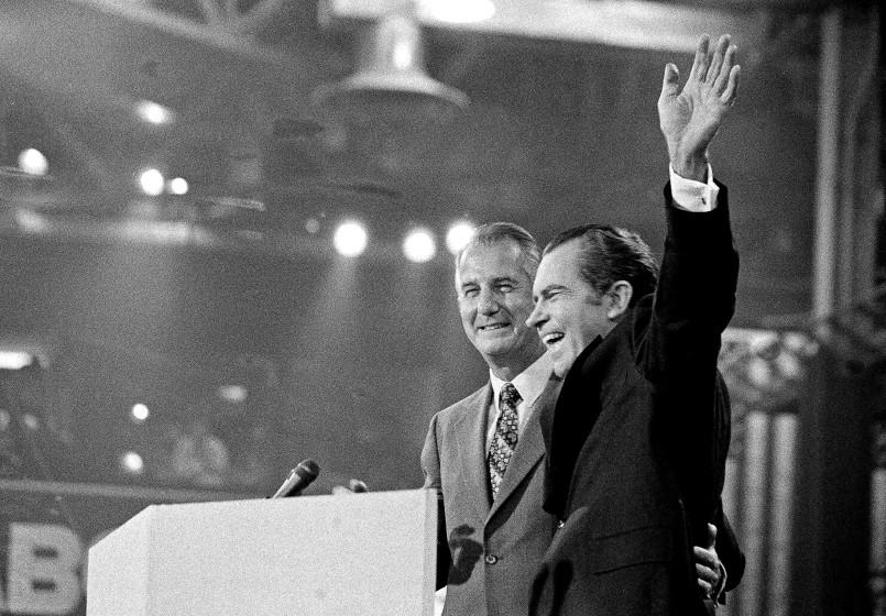 With Vice-president Spiro T. Agnew at his side, U.S. President Richard M. Nixon waves to the Republican National Convention delegates just before accepting the nomination for re-election in Miami, Fla., Aug. 23, 1972. (AP Photo)