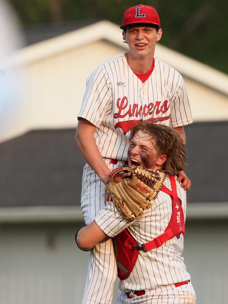Lakewood catcher Nate Gall lifts up pitcher Tyler Bebout after the Lancers beat Granville on Thursday.