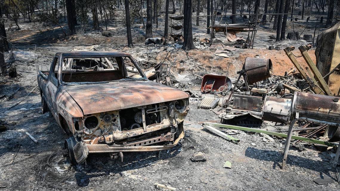 A burnt truck sits in the driveway of a home burned in the Oak Fire near Jerseydale Road in Mariposa County on Monday, July 25, 2022.