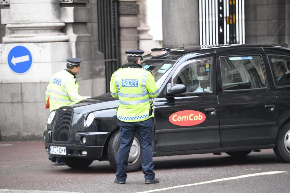 Met Police officers looking for motorists texting and talking on mobiles today at Trafalgar Square. (Jeremy Selwyn)