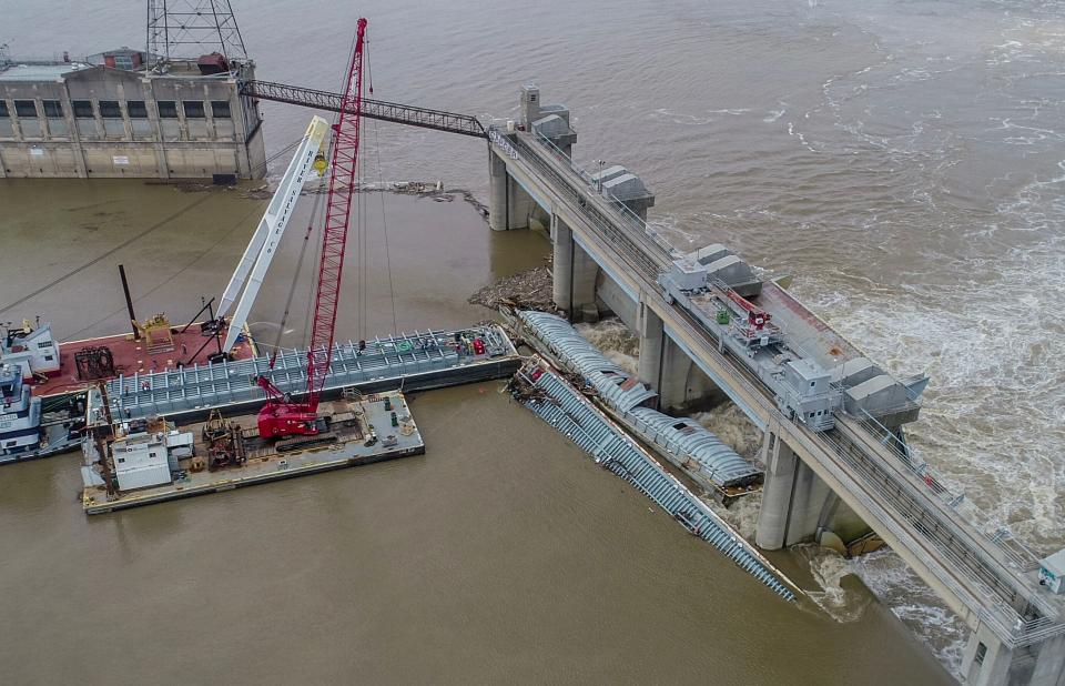 Crews prepare to pump methanol from a barge that broke away and lodged against the lower dam at McAlpine Locks at Louisville in April. The barge was carrying 1,400 tons of the toxic chemical, which was contained and did not spill into the Ohio River.