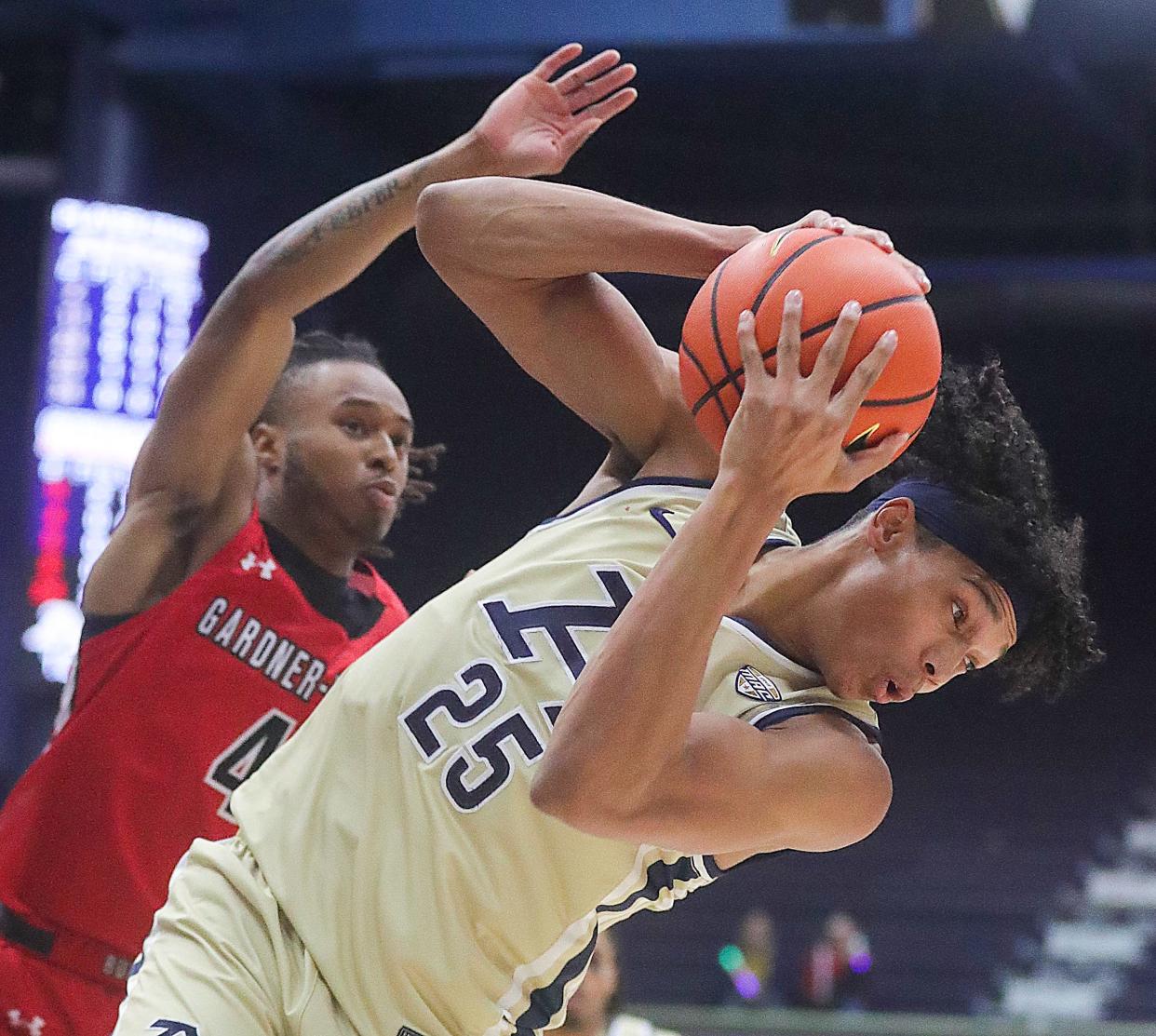 University of Akron's Enrique Freeman grabs a rebound in front of Gardner-Webb's Darrion Baker on Thursday, Dec. 21, 2023, in Akron, Ohio. [Phil Masturzo/ Beacon Journal]