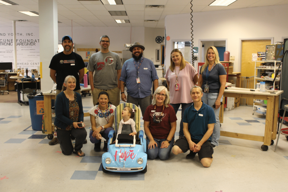 Staff from Cruces Creative, Lynn Community Middle School and Hope Harrison’s caretakers pose with Hope in her new mobility vehicle. at Cruces Creatives in Las Cruces on Friday, April 8, 2022.