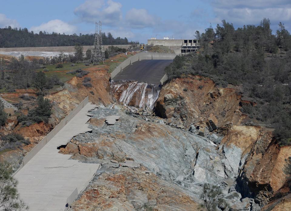 A small flow of water drops down Oroville Dam's crippled spillway in Oroville, Calif. on Feb. 28, 2017.