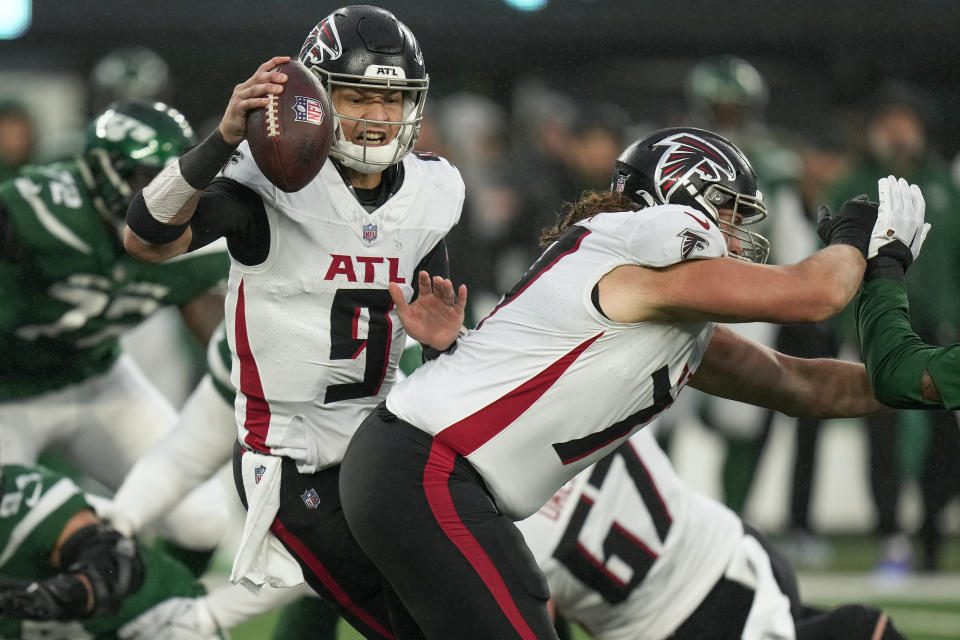 Atlanta Falcons quarterback Desmond Ridder (9) scrambles while passing against the New York Jets during the third quarter of an NFL football game, Sunday, Dec. 3, 2023, in East Rutherford, N.J. (AP Photo/Seth Wenig)