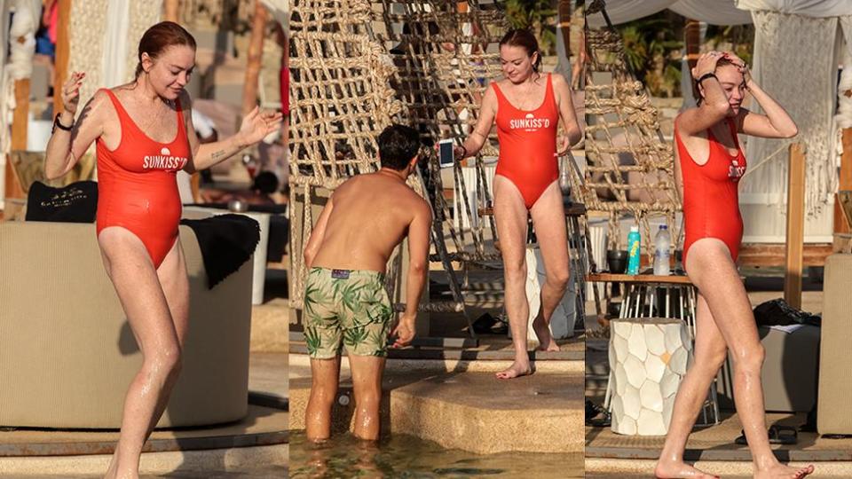 Lindsay Lohan soaks up the sun in a red swimsuit