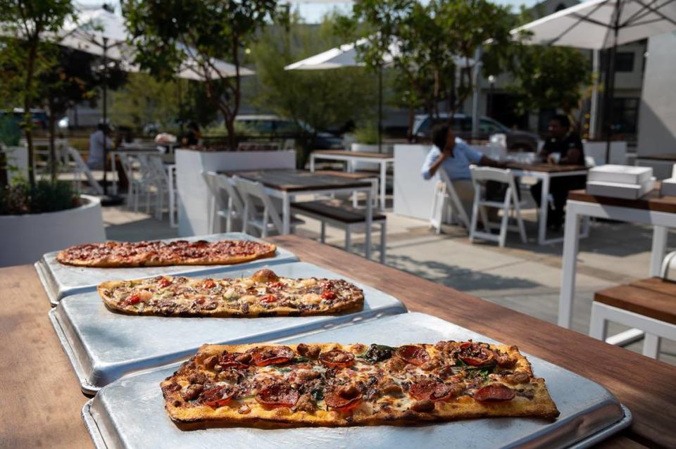 Pizzas available at Slim & Husky’s Pizza Beeria are displayed in their outdoor courtyard, Tuesday, Oct. 6, 2020, in Sacramento.