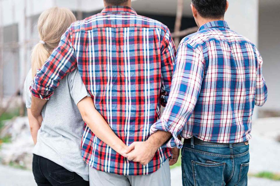 <p>Getty</p> Three people in a relationship (stock image)