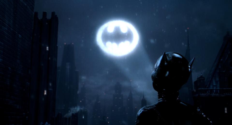 Catwoman looking up at the Bat signal