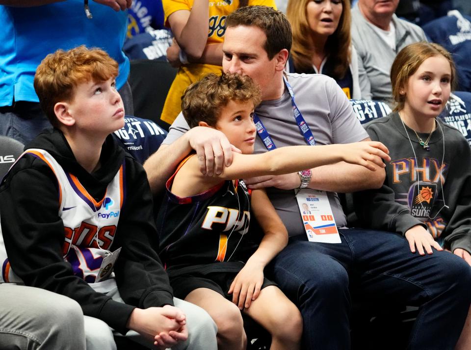 Phoenix Suns owner Mat Ishbia hugs and kisses his son before the tip-off against the Denver Nuggets in the first half during Game 1 of the Western Conference Semifinals at Ball Arena on April 29, 2023.