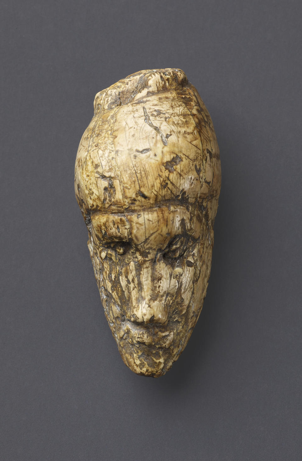 The oldest known portrait of a woman sculpted from mammoth ivory found at Dolní Věstonice, Moravia, Czech Republic. c.26,000 years old.  Height 4.8 cm. Moravian Museum, Anthropos Institute