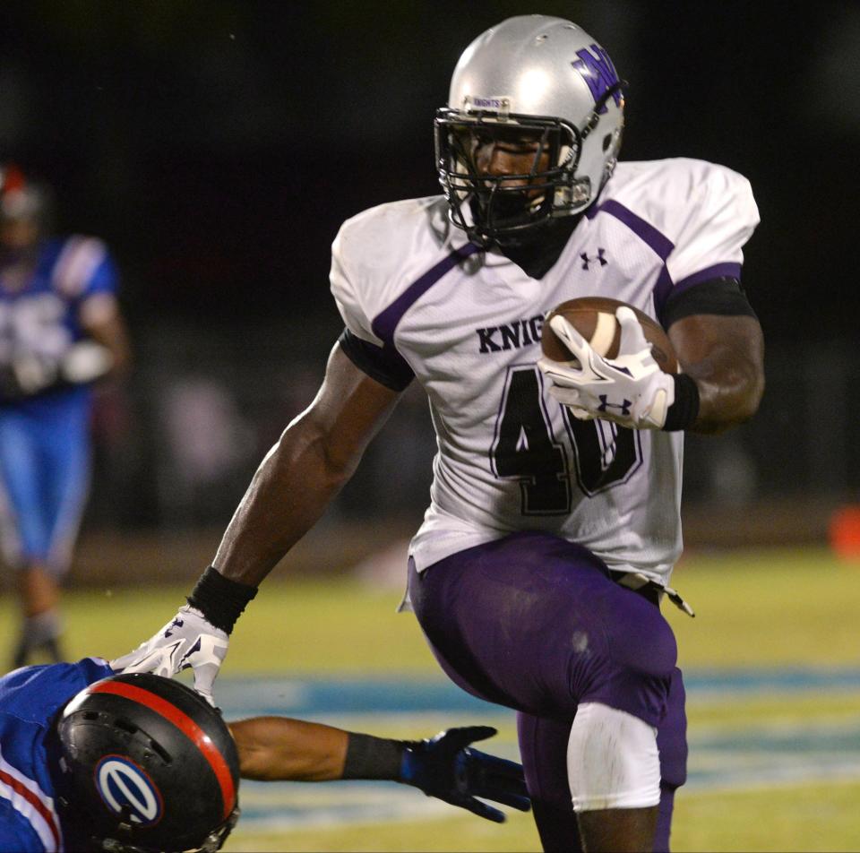North Webster’s Devin White stiff arms an opponent.