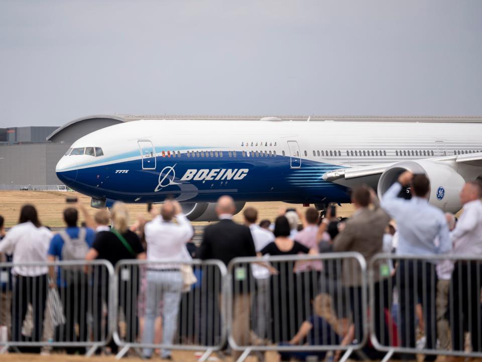 A Boeing 777X readies for its flying display in front of crowds at the Farnborough Airshow, on 20th July 2022, at Farnborough, England