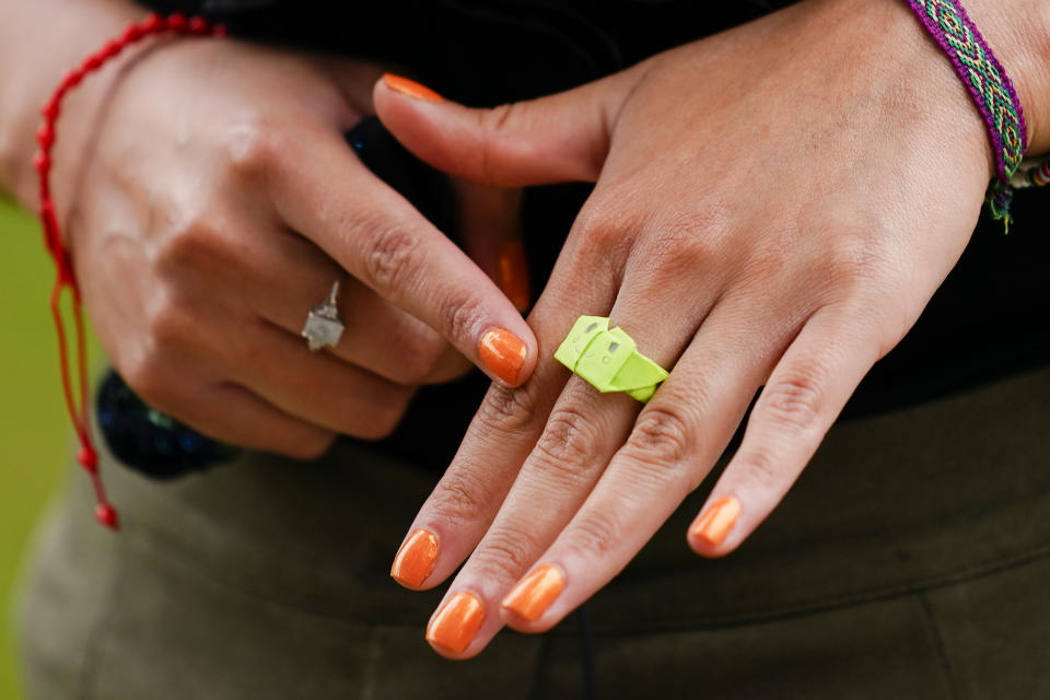 During an interview with The Associated Press, Wednesday, Oct. 6, 2021, in Philadelphia, Olivia Vazquez displays a paper ring her students made for her. Vazquez is finishing up her last semester at Swarthmore College and hoping to help make sure immigrant students arriving in Philadelphia have a more supportive experience in school than she did growing up. (AP Photo/Matt Rourke)