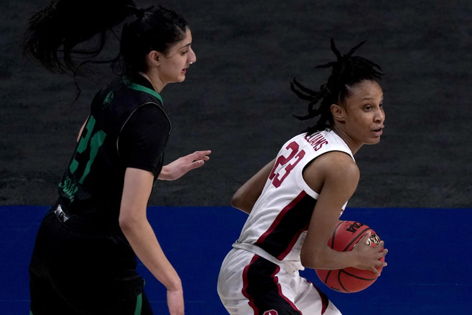 Stanford guard Kiana Williams (23) is pressured by Utah Valley forward Nehaa Sohail (21) during the first half of a college basketball game in the first round of the women's NCAA tournament at the Alamodome in San Antonio, Sunday, March 21, 2021. (AP Photo/Charlie Riedel)