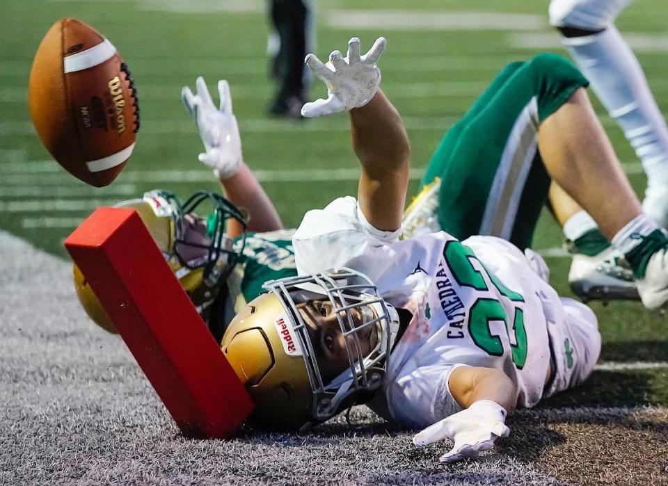 Cathedral's Michael Page (22) loses control of the ball while sliding in the corner of the end zone Friday, August 20, 2021, at Westfield High School. Cathedral defeated Westfield, 14-0.