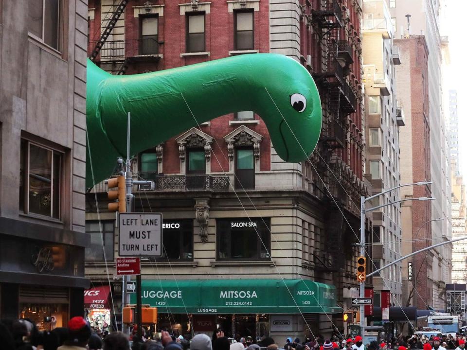 Sinclair's DINO balloon flies as the parade passes down 6th Avenue (Reuters)