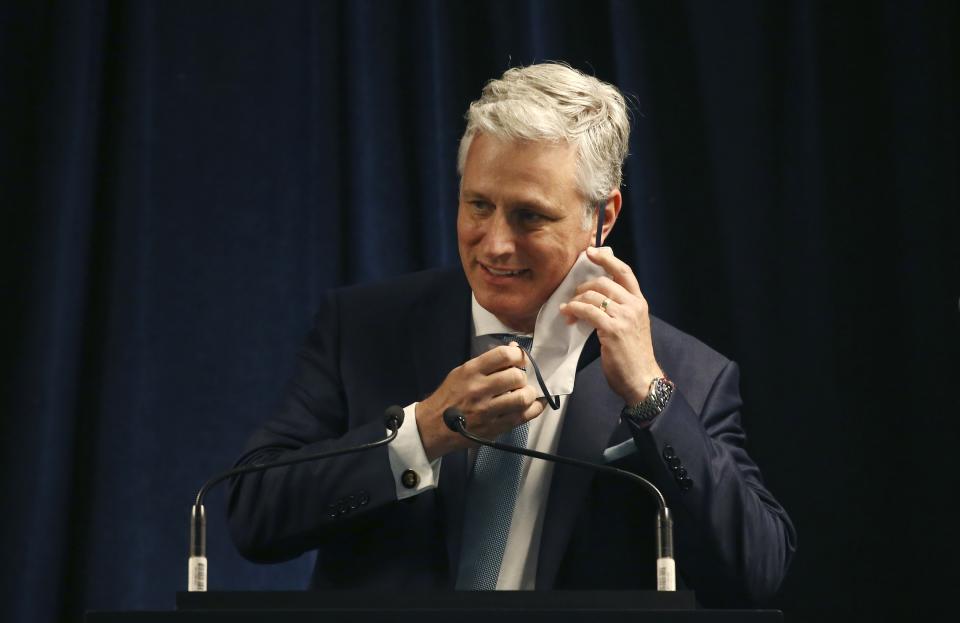 Robert O'Brien, assistant to the president for national security affairs, removes a face covering prior to speaking during a news conference regarding China Wednesday, June 24, 2020, in Phoenix. (AP Photo/Ross D. Franklin)