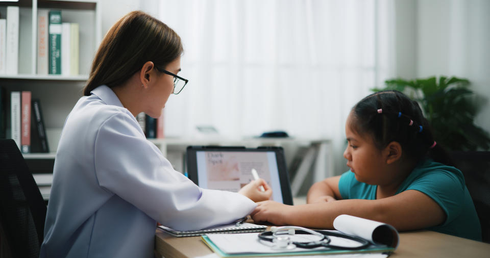 dermatologist talking with a child patient