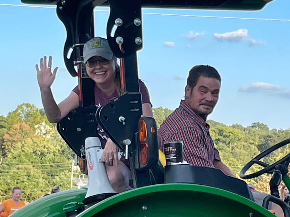 Adrienne and Bill Toro give a wave from their tractor as they pull about 20 folks on a hayride at the annual Family Festival held at West Town Christian Church, 9300 Middlebrook Pike.