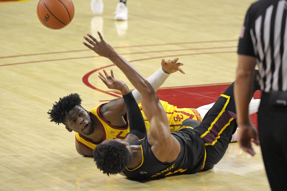 Southern California forward Chevez Goodwin, left, defends as Arizona State forward Kimani Lawrence passes the ball after a scramble for it during the first half of an NCAA college basketball game Wednesday, Feb. 17, 2021, in Los Angeles. (AP Photo/Mark J. Terrill)