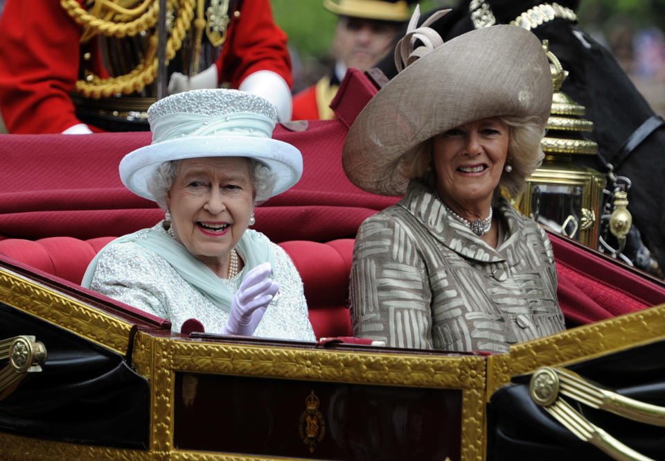 Britain's Queen Elizabeth , left, and Camilla Duchess of Cornwall pass along The Mall as part of a four-day Diamond Jubilee celebration to mark the 60th anniversary of Elizabeth II accession to the throne, London, Tuesday, June, 5, 2012. Pealing church bells and crowds cheering "God save the queen!" greeted Queen Elizabeth II on Tuesday as she arrived for a service at St. Paul's Cathedral on the last of four days of Diamond Jubilee celebrations honoring her 60 years on the throne. (AP Photo/Tom Hevezi, Pool)