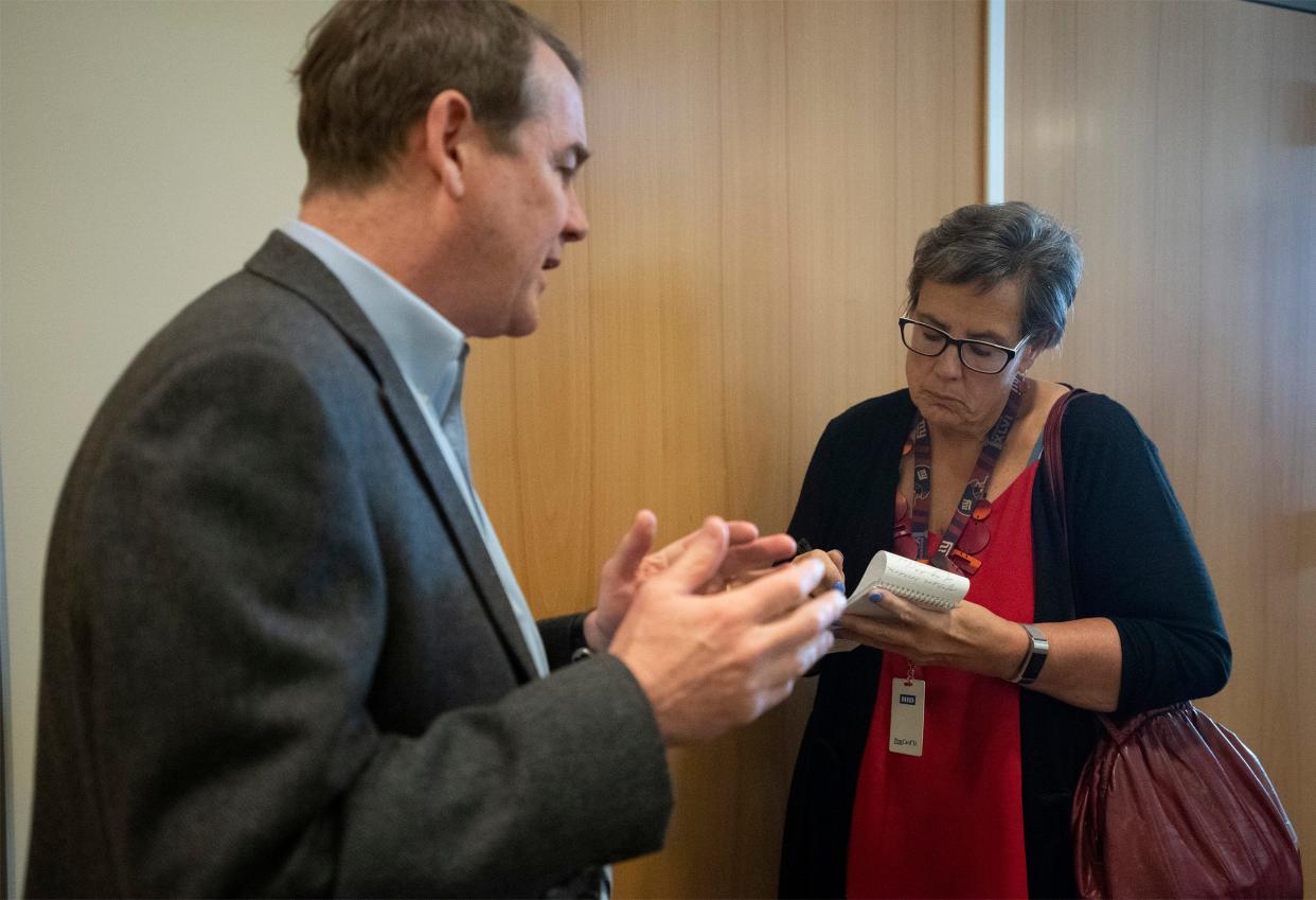 Coloradoan reporter Pat Ferrier, right, takes notes as Democratic Sen. Michael Bennet discusses the early stages of the COVID-19 vaccine development after his tour at the Colorado State University Infectious Disease Research Lab in Fort Collins in 2020.