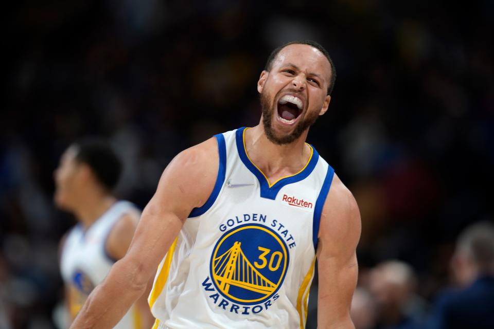 Golden State Warriors guard Stephen Curry reacts after Jordan Poole hit a 3-point basket late in the second half of the team's NBA basketball game against the Denver Nuggets on Thursday, March 10, 2022, in Denver. (AP Photo/David Zalubowski)