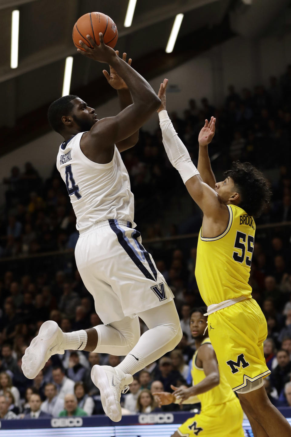 Villanova's Eric Paschall, left, goes up for a shot against Michigan's Eli Brooks during the first half of an NCAA college basketball game, Wednesday, Nov. 14, 2018, in Villanova. (AP Photo/Matt Slocum)