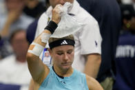 FILE - Karolina Muchova, of the Czech Republic, holds a bag of ice on her head to cool down between games against Sorana Cirstea, of Romania, during the quarterfinals of the U.S. Open tennis championships, Sept. 5, 2023, in New York. An Associated Press analysis shows the average high temperatures during the U.S. Open and the three other Grand Slam tennis tournaments steadily have grown hotter and more dangerous in recent decades. (AP Photo/Charles Krupa, File)