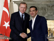 Greek Prime Minister Alexis Tsipras and Turkish President Tayyip Erdogan attend a press conference following their meeting at the Maximos Mansion in Athens, Greece December 7, 2017. REUTERS/Costas Baltas