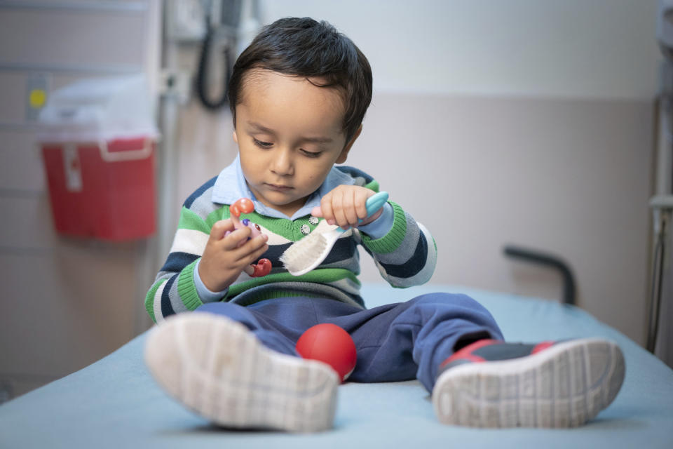 In this April 2019 photo provided by the St. Jude Children's Research Hospital, 2-year-old Gael Jesus Pino Alva plays with toys at the hospital in Memphis. Gael was one of eight babies with "bubble boy disease" who have had it corrected by gene therapy that ironically was made from one of the immune system's worst enemies _ HIV, the virus that causes AIDS. (Peter Barta/St. Jude Children's Research Hospital via AP)