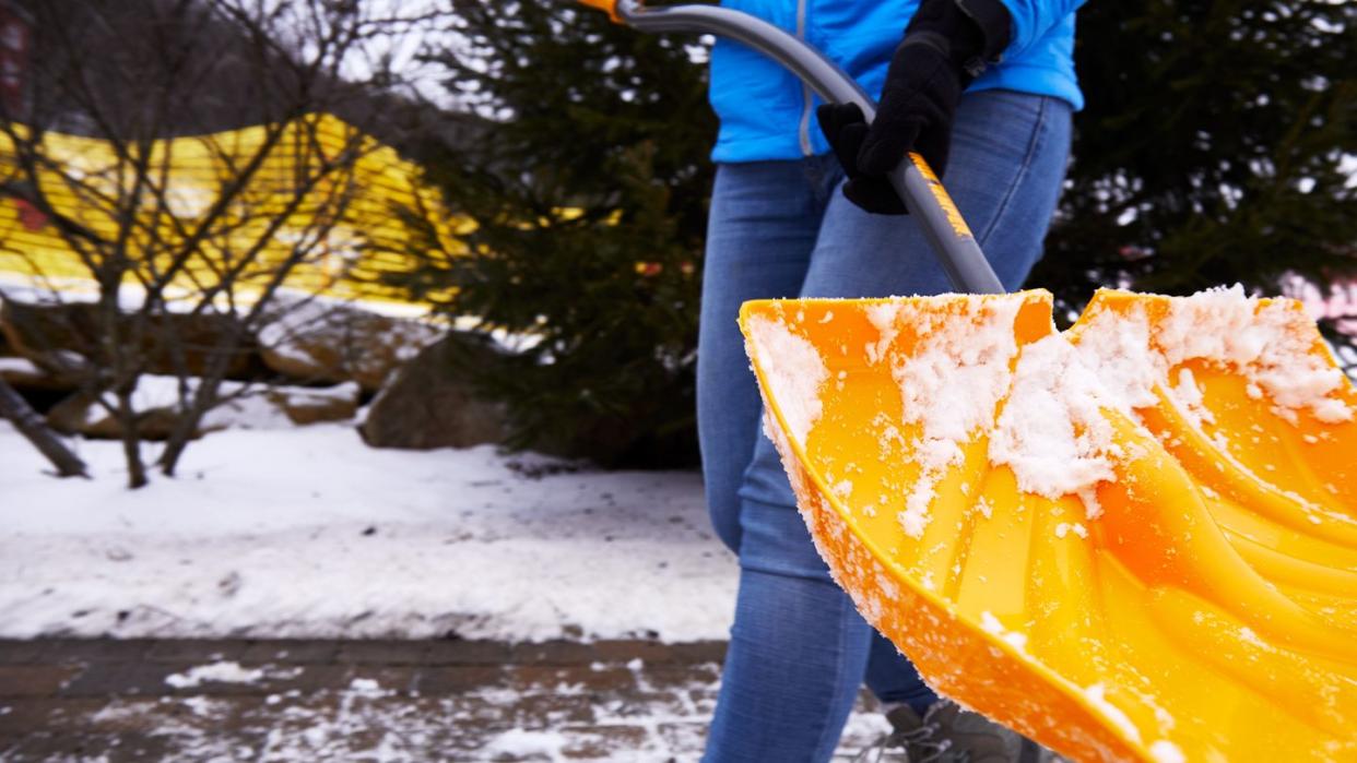 a person using a snow shovel