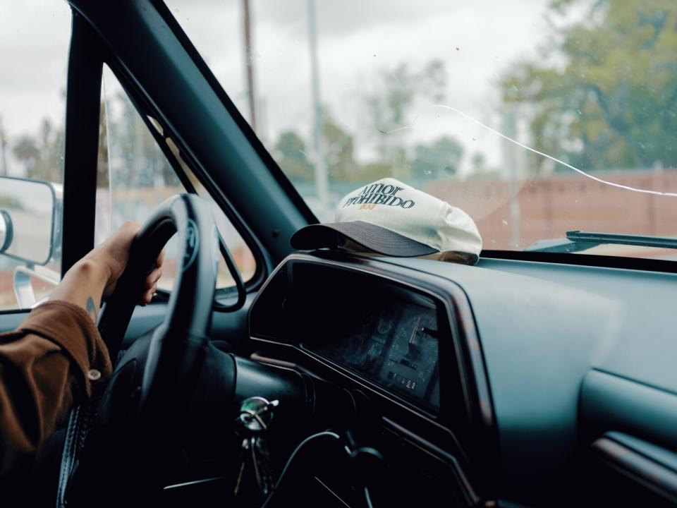 Preciado behind the wheel of his '91 baby blue Ford F-150.