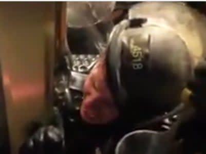 A US Capitol police officer is crushed between a door and a throng of Trump supporters during the US Capitol riot in Washington DC on 6 January. (Screengrab via New York Post)