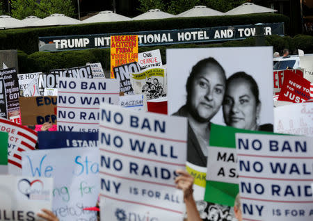 People march and chant slogans against President Donald Trump's proposed end of the DACA program that protects immigrant children from deportation at a protest in front of Trump International Hotel in New York City, U.S., August 30, 2017. REUTERS/Joe Penney/Files