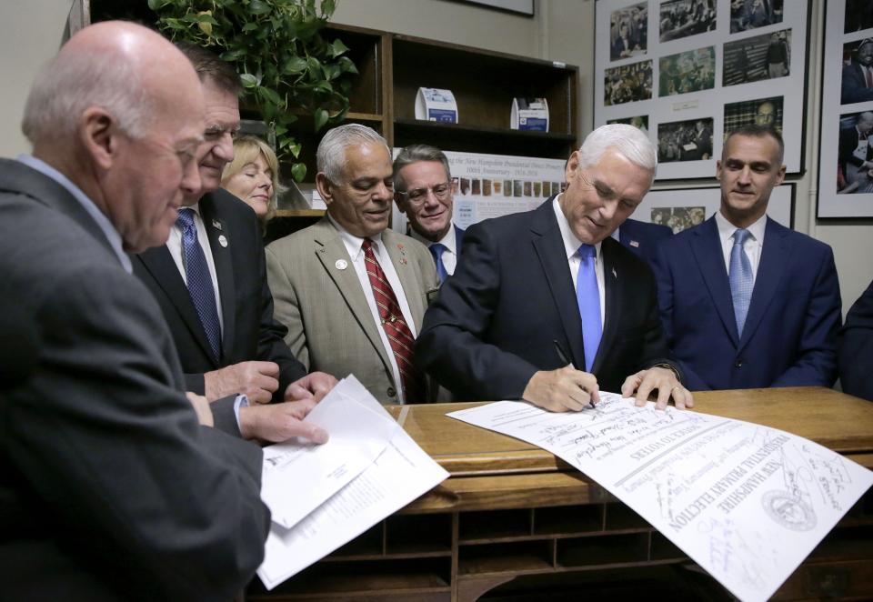 Republican Vice President Mike Pence files for President Donald Trump to be listed on the New Hampshire primary ballot, Thursday, Nov. 7, 2019, at the Secretary of State's office in Concord, N.H. Watching at left is New Hampshire Secretary of State Bill Gardner. (AP Photo/Charles Krupa)