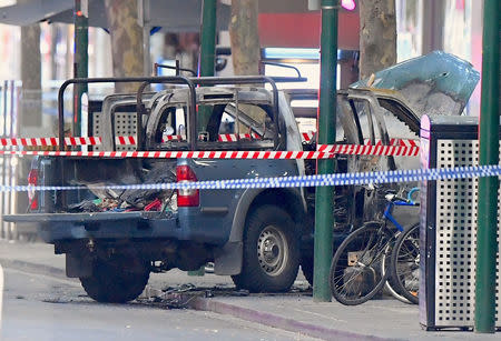 A burnt out vehicle is surrounded by police tape on Bourke Street in central Melbourne, Australia, November 9, 2018. AAP/James Ross/via REUTERS