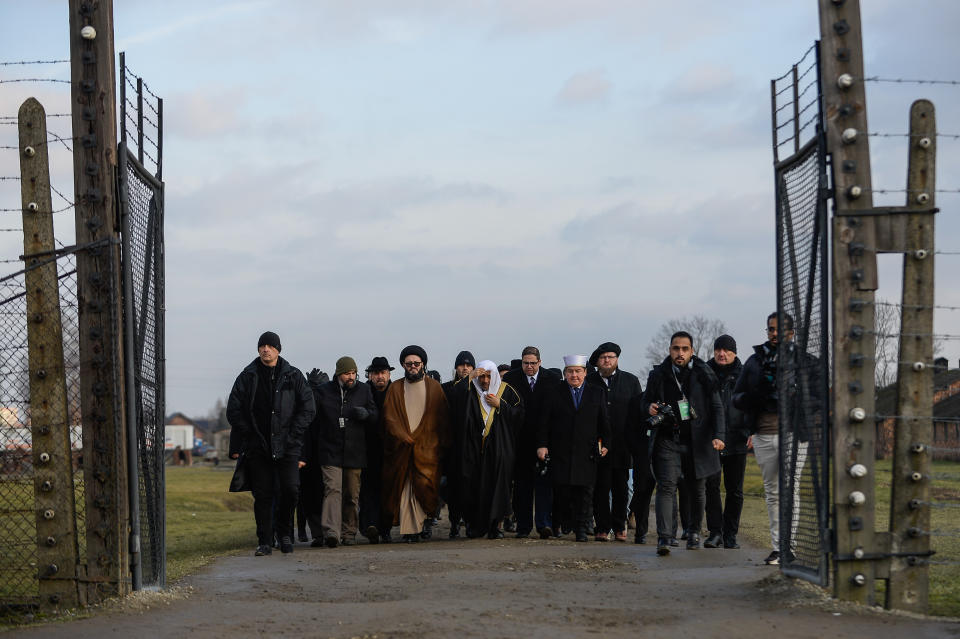 Sheikh Mohammed al-Eissa and others walk into the camp to pay their respects.