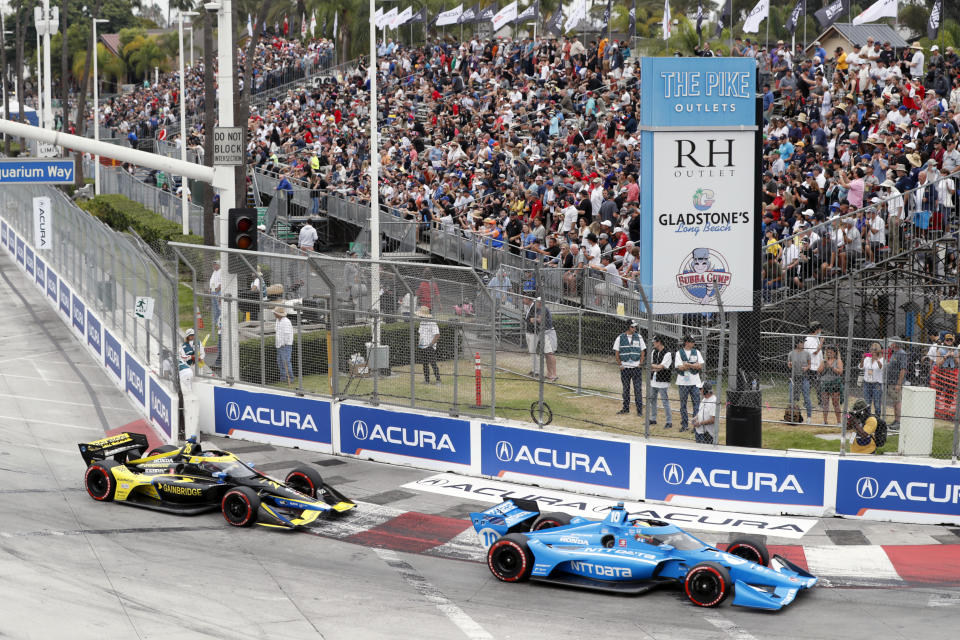 IndyCar series points leader Alex Palou (10) takes Turn 1 with Colton Herta (26) during an auto race at Grand Prix of Long Beach auto race Sunday, Sept. 26, 2021, in Long Beach, Calif. (AP Photo/Alex Gallardo)