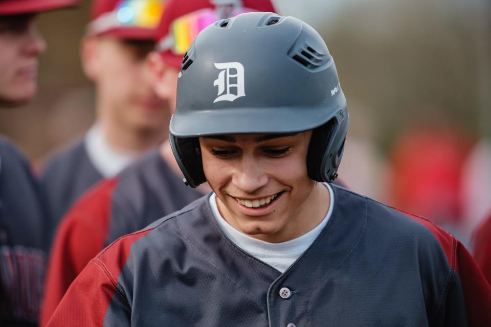 Dover's James Leggett is all smiles after scoring a run against New Phila Friday night.