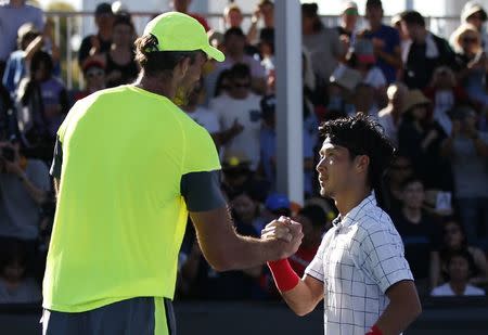 Tennis - Australian Open - Melbourne, Australia, January 17, 2018. Ivo Karlovic of Croatia shakes hands with Yuichi Sugita of Japan after Karlovic won their match. REUTERS/Toru Hanai